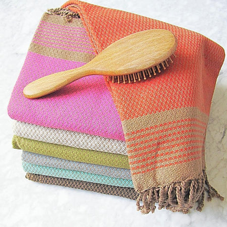 colourful pile of large cotton hammam towel with honeycomb pattern and hand finished tassels